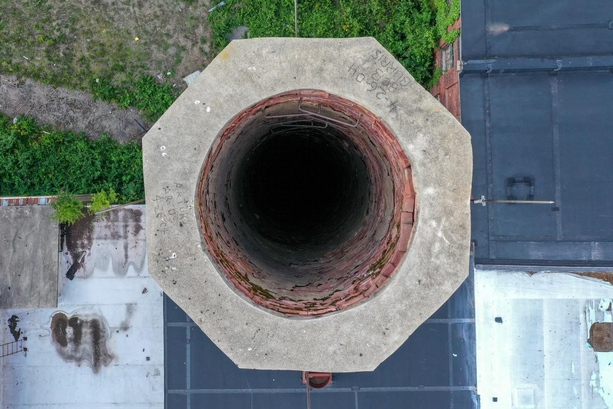 a close up, straight on photograph of the barrel of a smoke stack